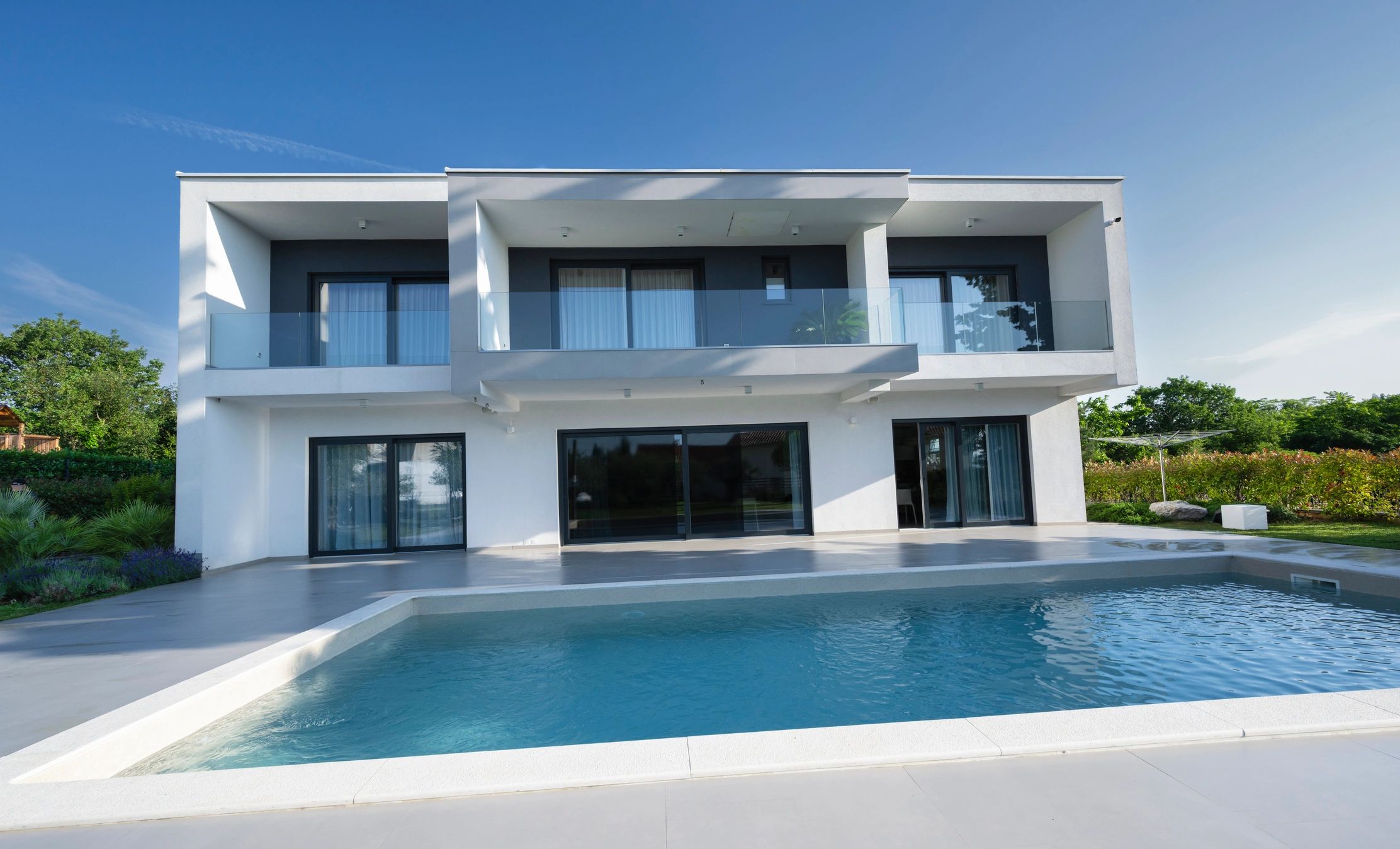 Luxury villa exterior with swimming pool and landscaping